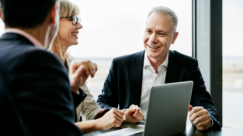 Three people at a meeting